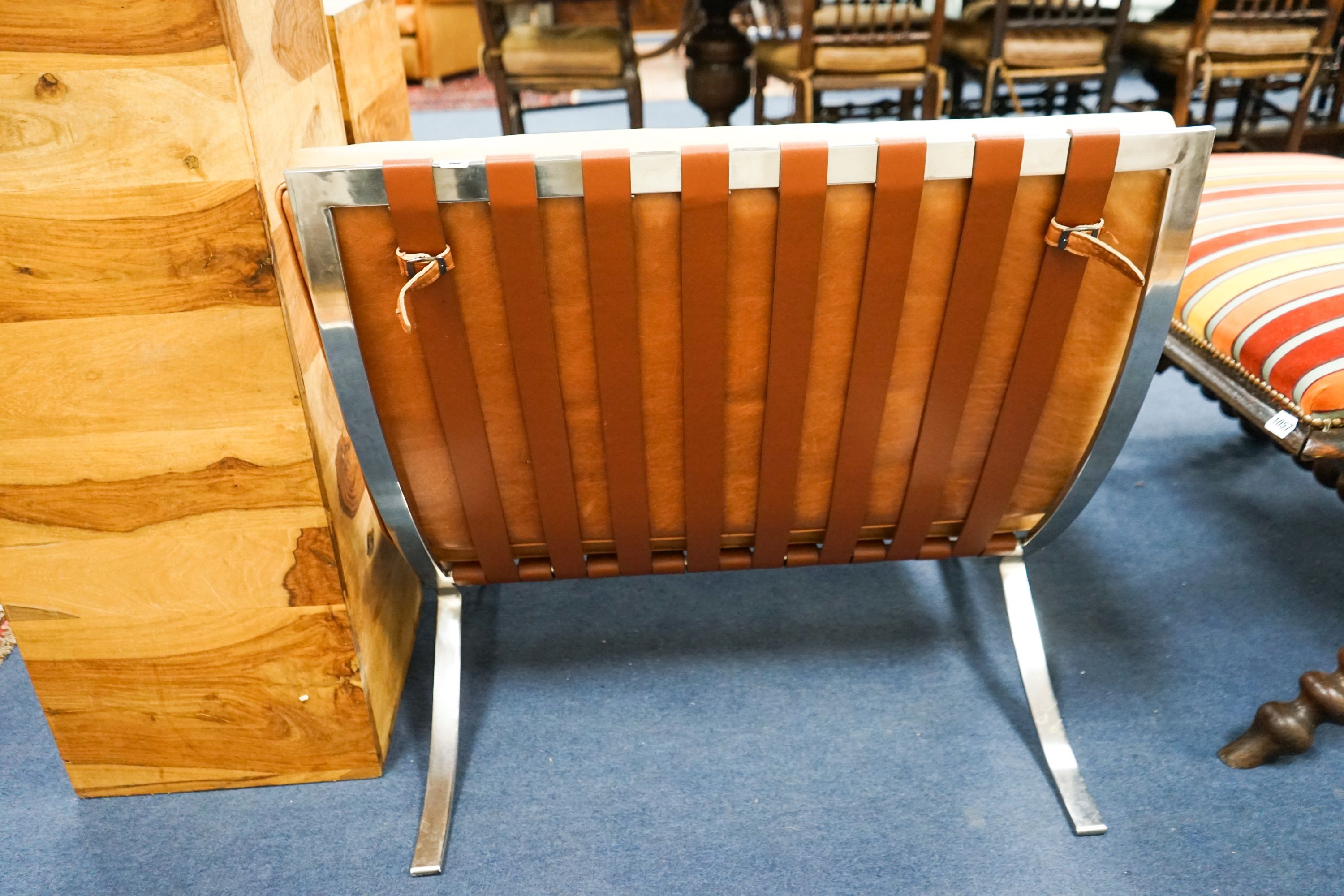 A brown leather and chrome Barcelona type chair, width 76cm, depth 70cm, height 74cm